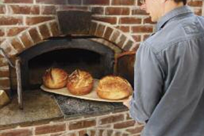 Jesse Merrill of Polestar Hearth puts bread in the oven