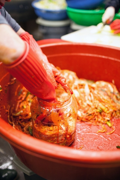kimchi being packed into jars